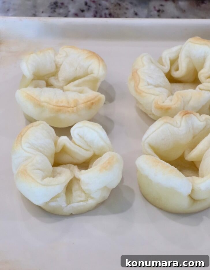 Braised Short Rib Pot Pie with French Onion 21 puff pastry shells on a baking sheet