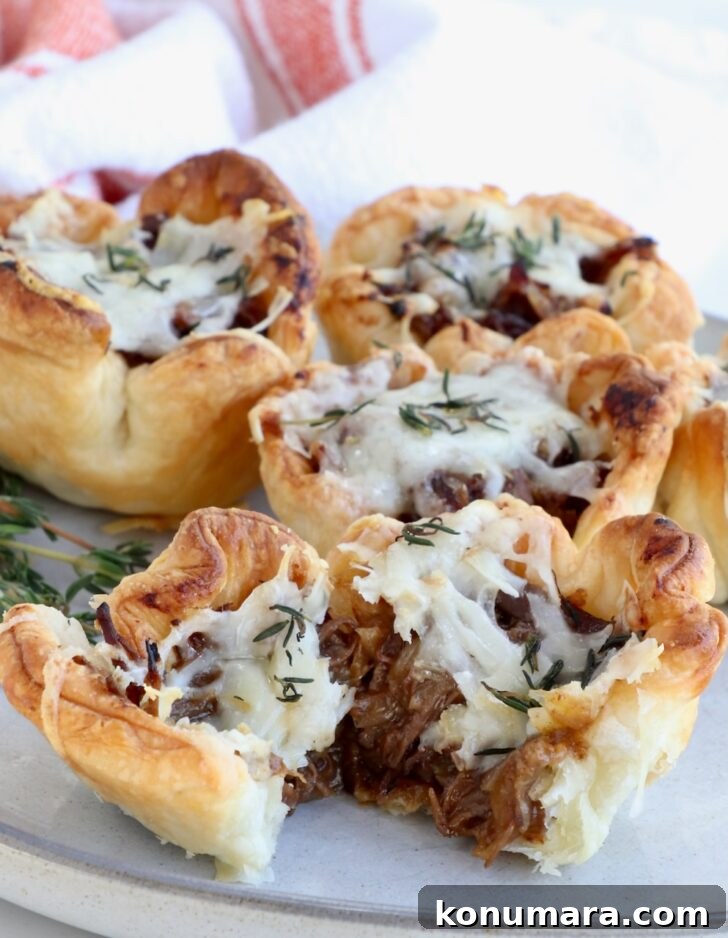 Braised Short Rib Pot Pie with French Onion 24 mini short rib pot pies on a plate with one cut in half to reveal the inside shredded beef filling