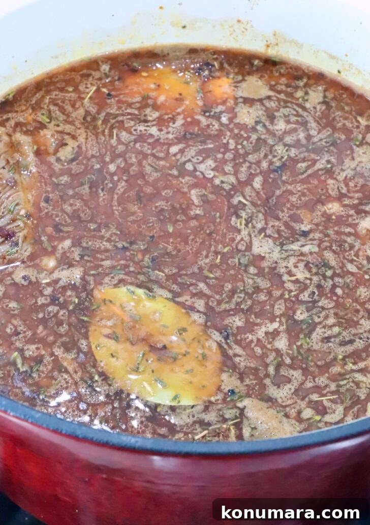 Braised Short Rib Pot Pie with French Onion 8 short ribs covered in beef broth, herbs and a bay leaf in a large pot