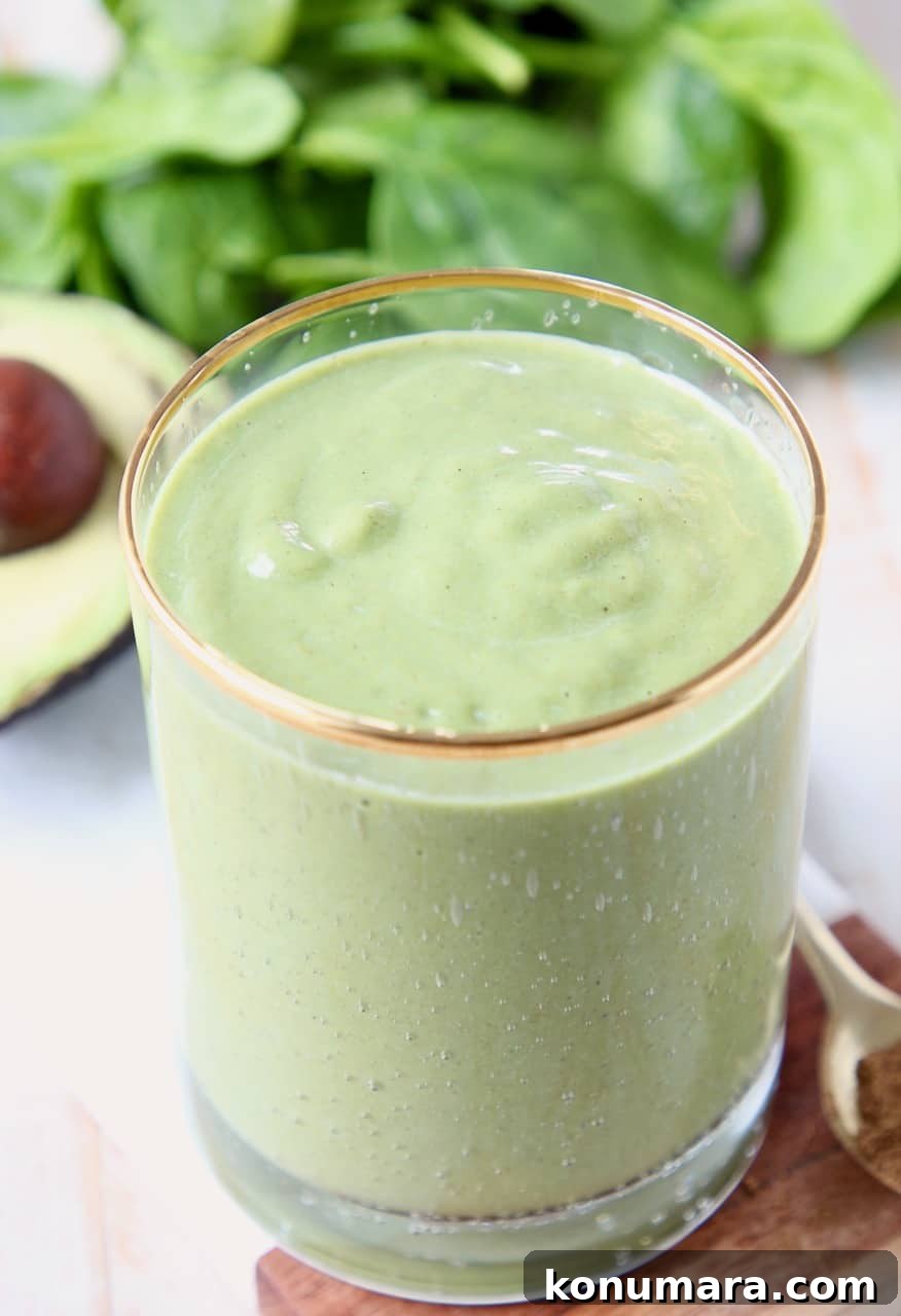 Superfood Green Smoothie Recipe with Spinach and Avocado 4 Green smoothie in clear glass with gold rim