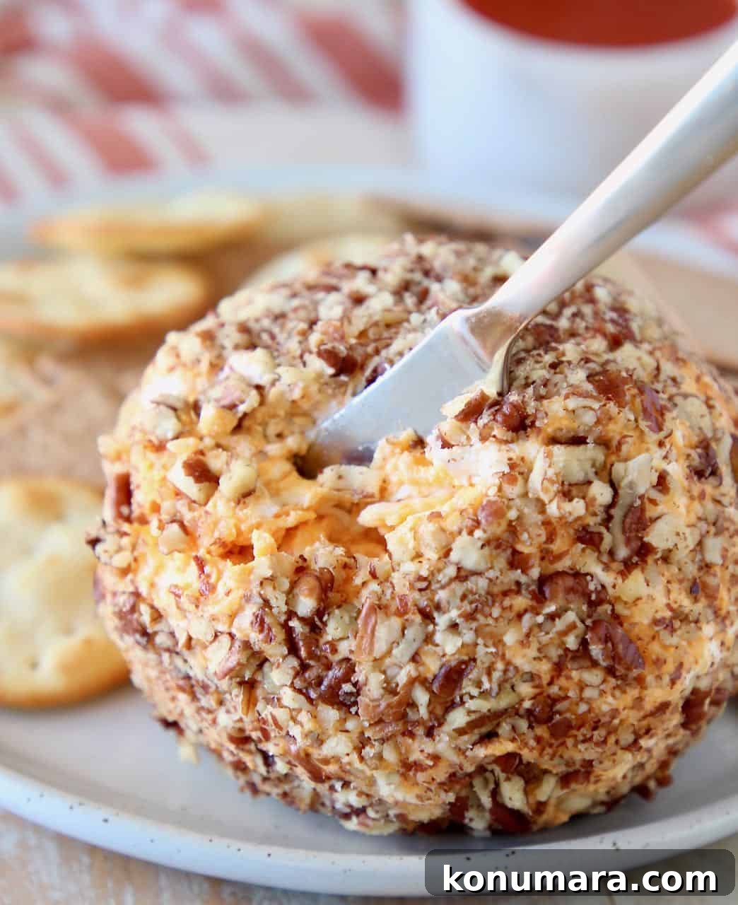 Cheese ball with cheese knife stuck in it