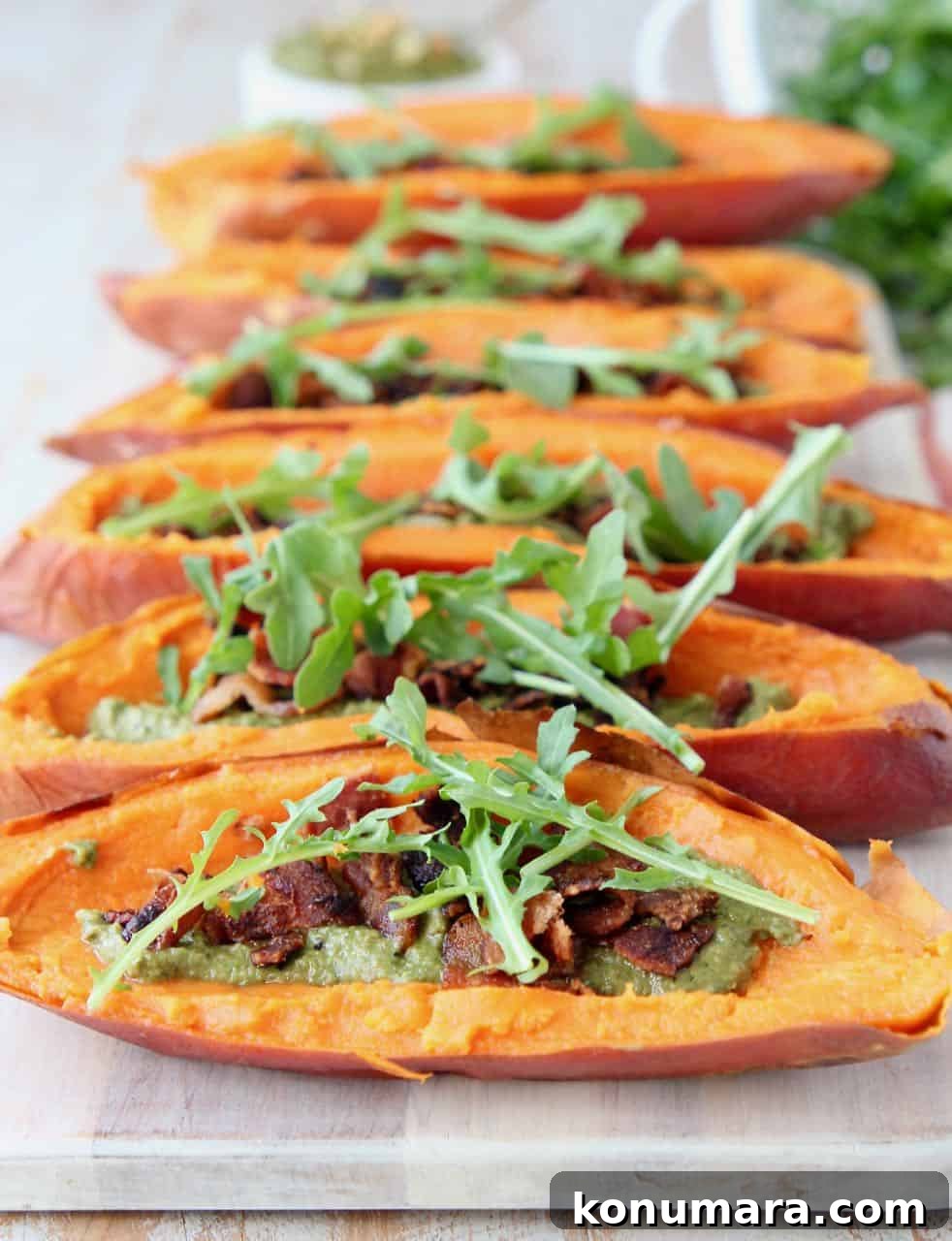 Loaded Sweet Potato Skins with Sage Pesto and Crispy Bacon 2 Loaded sweet potato skins on wood serving tray