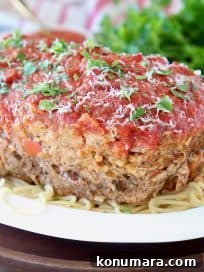 Classic Italian Meatloaf Recipe with Marinara Glaze 10 Italian Meatloaf sitting on large bowl of spaghetti noodles with fresh parsley on top