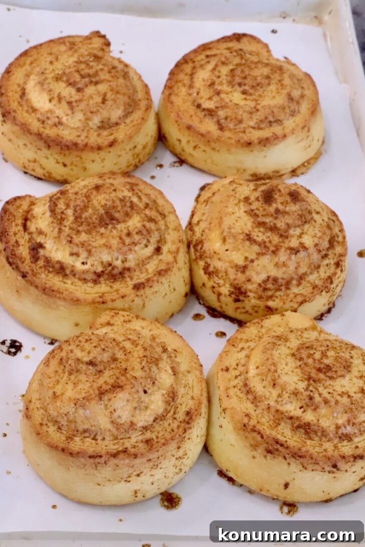 Cheesy Cornbread Rolls Recipe: Soft, Melty Centers 11 baked cornbread rolls on a parchment lined baking pan