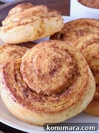 Cheesy Cornbread Rolls Recipe: Soft, Melty Centers 13 seasoned, baked cornbread rolls stacked up on a plate