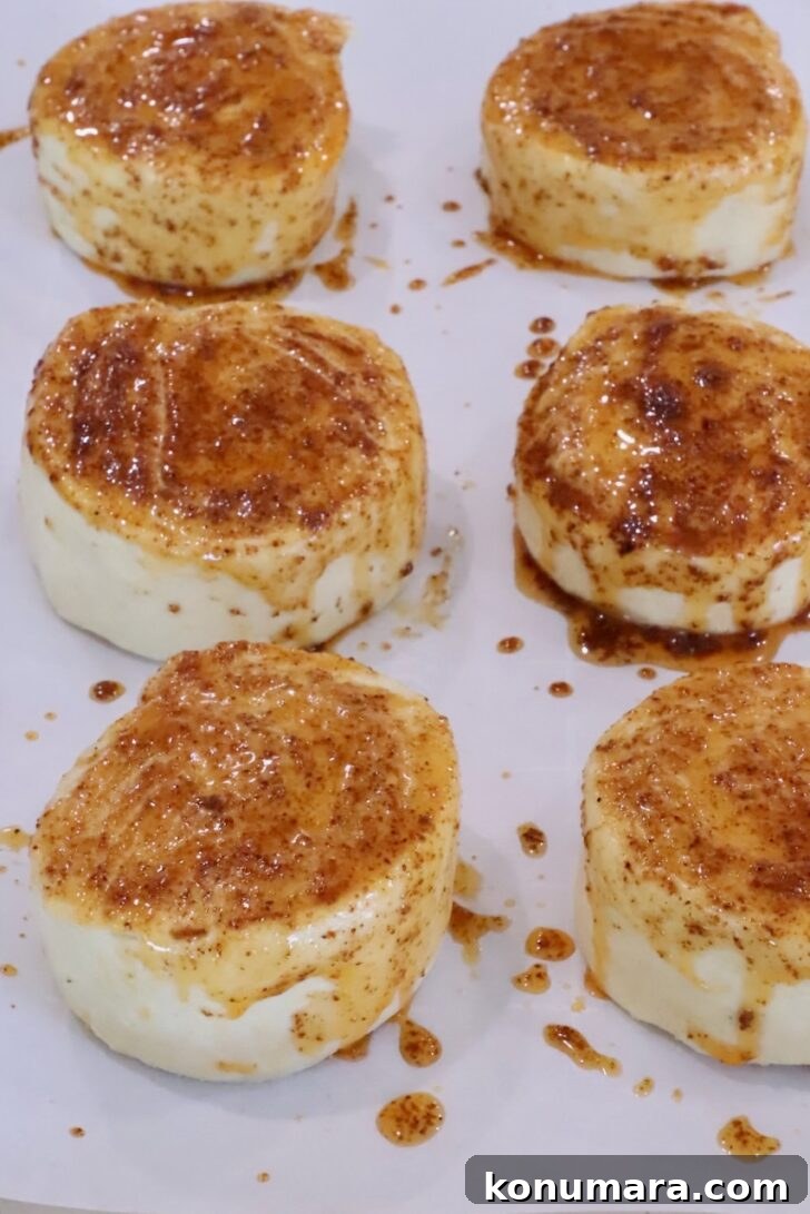Cheesy Cornbread Rolls Recipe: Soft, Melty Centers 10 cornbread rolls on a baking sheet, topped with seasoned melted butter