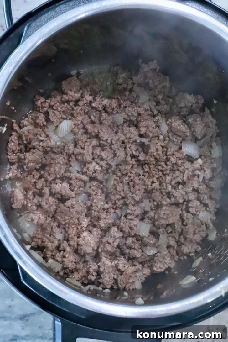 cooked ground beef and onions in an instant pot