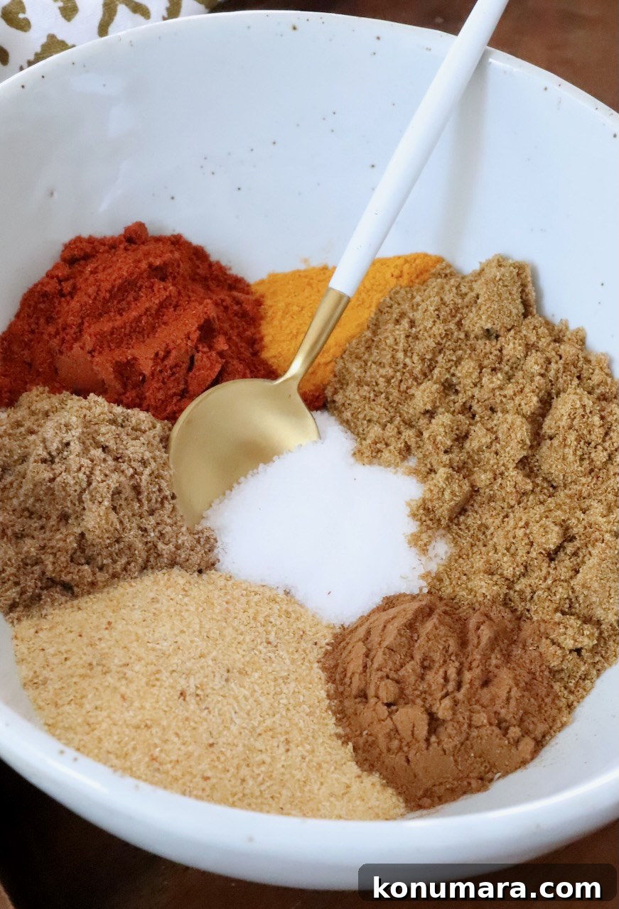 several different spices separated in a bowl with a spoon