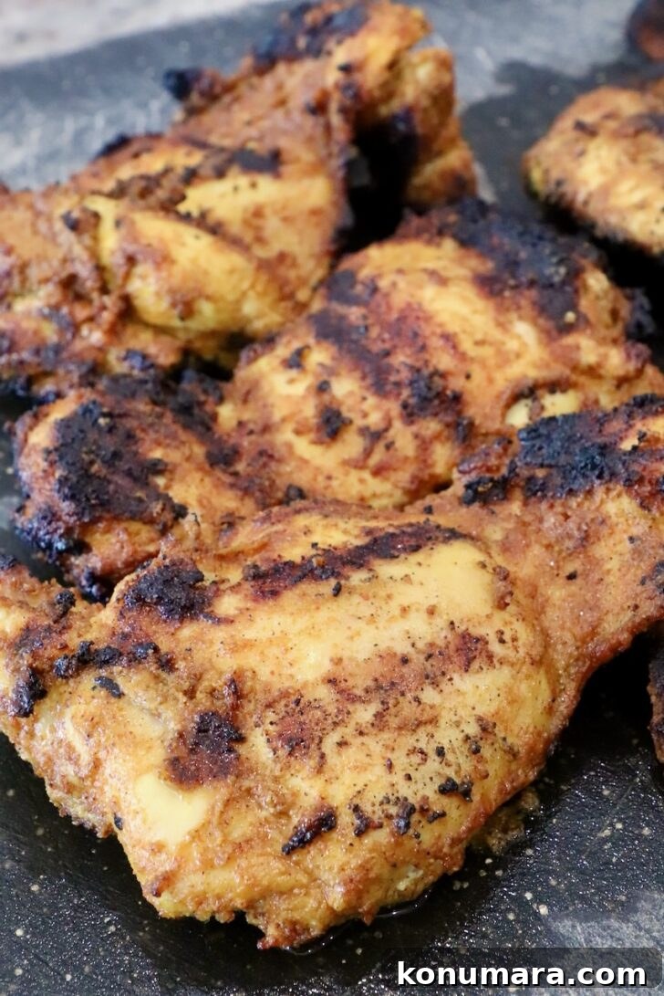 Chicken Shawarma Tacos with Garlic Yogurt Sauce 8 grilled shawarma chicken thighs on a black cutting board