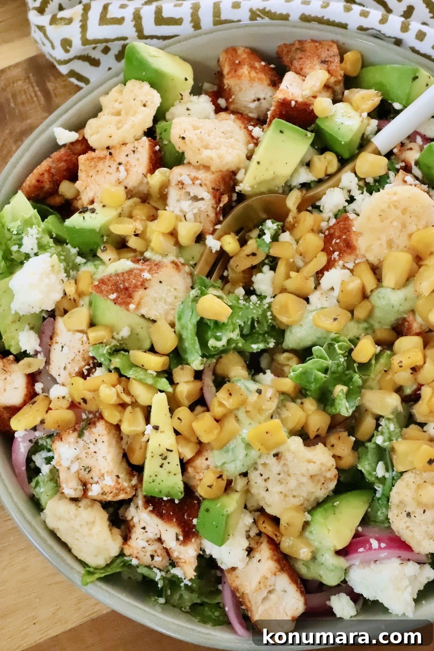Chicken Taco Salad with Creamy Poblano Ranch 6 chicken taco salad in a bowl topped with cilantro, diced avocado, and cheese crisps