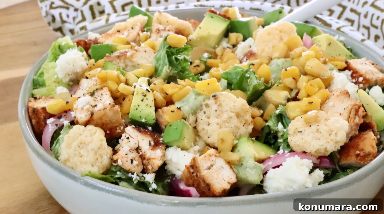 Chicken Taco Salad with Creamy Poblano Ranch 7 taco salad in a bowl topped with diced chicken, cheese crips, corn and avocado