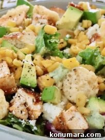 Chicken Taco Salad with Creamy Poblano Ranch 8 taco salad topped with diced chicken, avocado, corn, and cheese crisps
