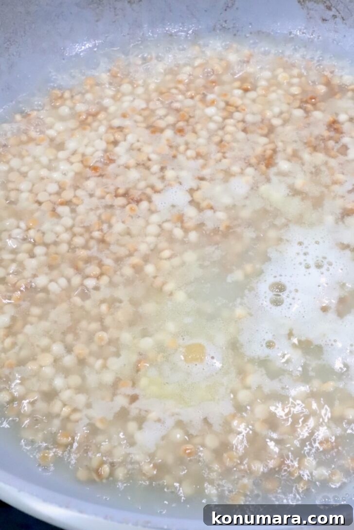 Autumn Harvest Grain Bowl with Roasted Squash and Quinoa 6 couscous simmering in water in a skillet