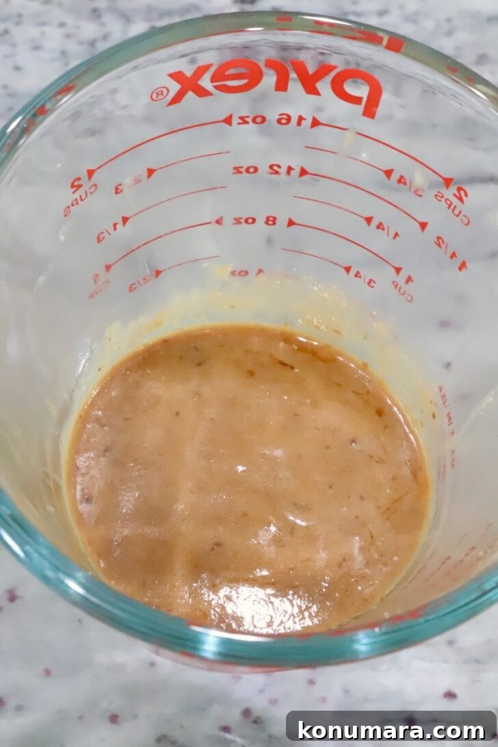miso ginger sauce mixed up in a glass measuring cup