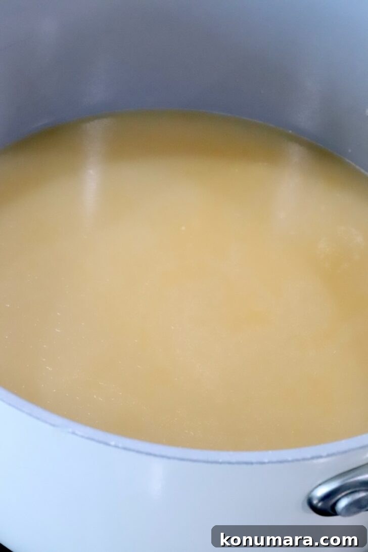 miso ginger chicken bone broth in a pot on the stove